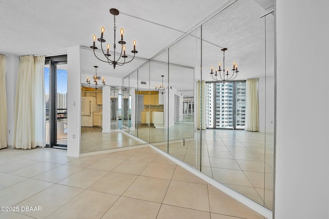 1 Oceans W Blvd Unit 8A2, Daytona Beach, FL 32118 - unfurnished dining area with a chandelier, healthy amount of natural light, a textured ceiling, and tile patterned flooring