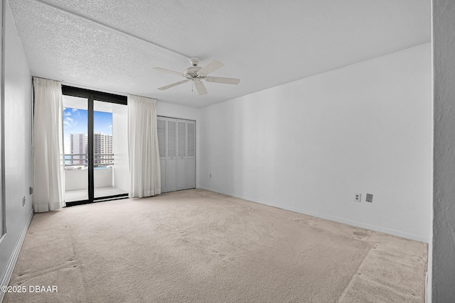 1 Oceans W Blvd Unit 8A2, Daytona Beach, FL 32118 - empty room with a ceiling fan, carpet flooring, baseboards, and a textured ceiling