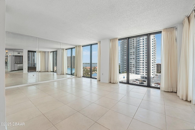 1 Oceans W Blvd Unit 8A2, Daytona Beach, FL 32118 - tiled empty room featuring expansive windows and a textured ceiling