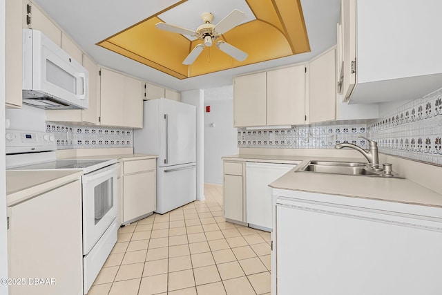 1 Oceans W Blvd Unit 8A2, Daytona Beach, FL 32118 - kitchen with white appliances, a sink, ceiling fan, light countertops, and backsplash