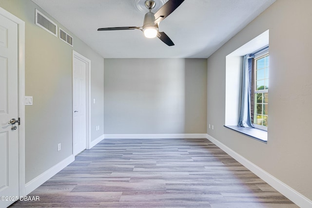 unfurnished room with ceiling fan and light hardwood / wood-style flooring