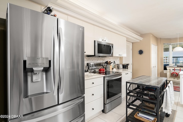 kitchen featuring backsplash, white cabinets, light tile patterned floors, and stainless steel appliances