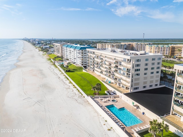 birds eye view of property featuring a water view and a beach view