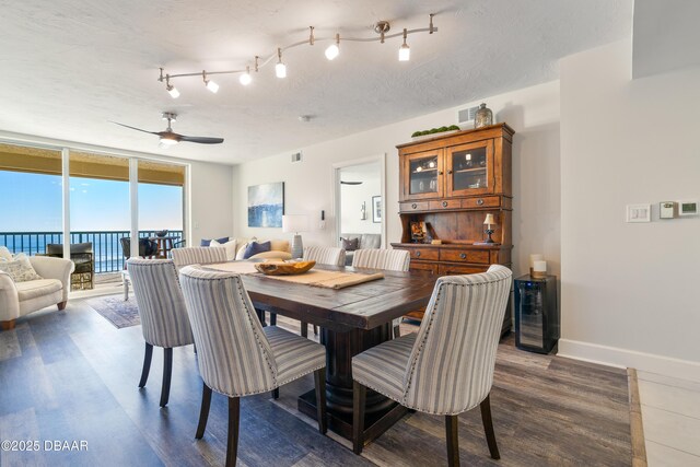 kitchen with stainless steel appliances, light tile patterned floors, ornamental molding, a tray ceiling, and white cabinetry