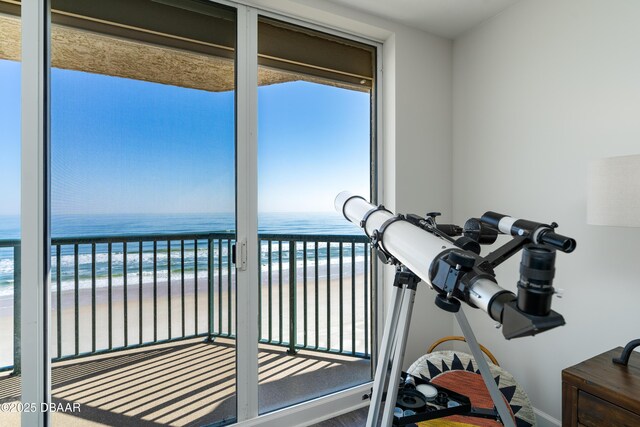 living room with expansive windows, light hardwood / wood-style floors, ceiling fan, and a water view