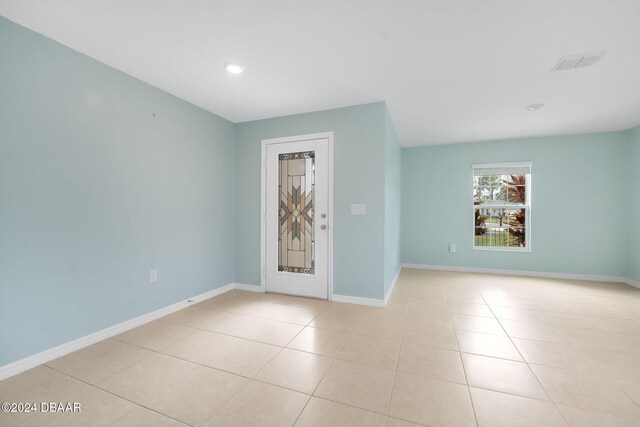 unfurnished room featuring light tile patterned floors