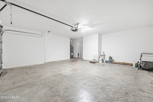 garage featuring water heater and a garage door opener