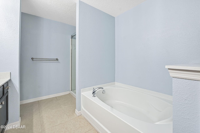 bathroom with vanity, a textured ceiling, tile patterned floors, and independent shower and bath