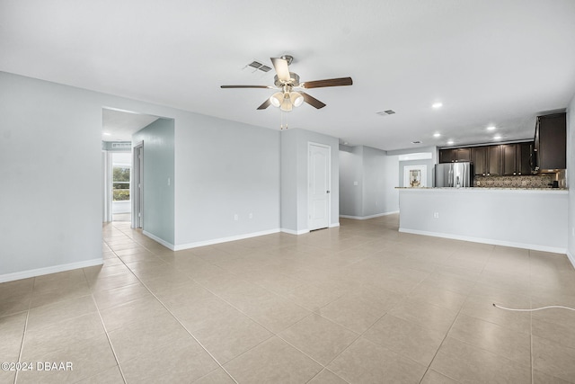 unfurnished living room with ceiling fan and light tile patterned flooring