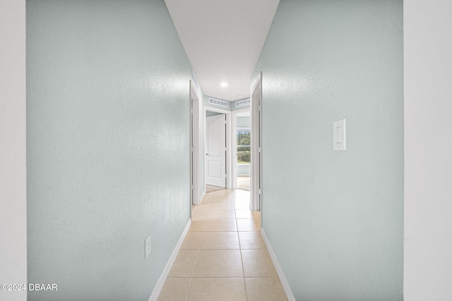 hallway featuring light tile patterned flooring