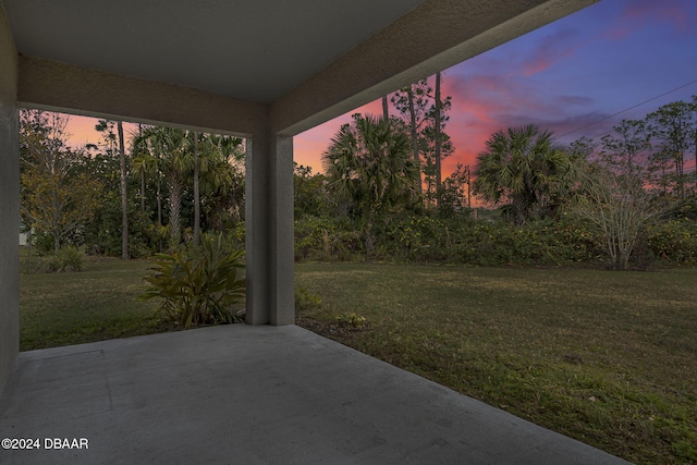 yard at dusk with a patio area