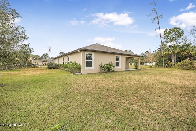back of property featuring a yard