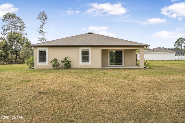rear view of house featuring a patio area and a yard