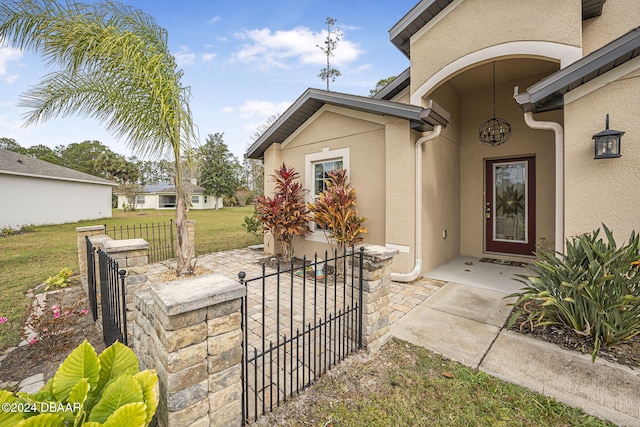 view of exterior entry featuring a yard