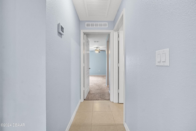corridor featuring light tile patterned flooring