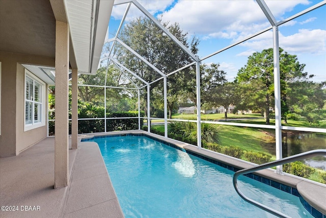 view of pool featuring glass enclosure and a patio