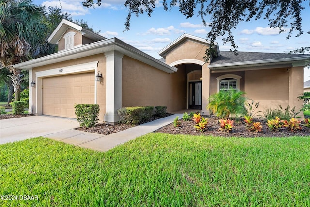 view of front of home featuring a garage and a front lawn