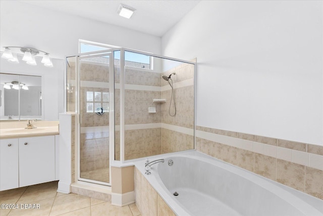 bathroom with plus walk in shower, tile patterned floors, and vanity