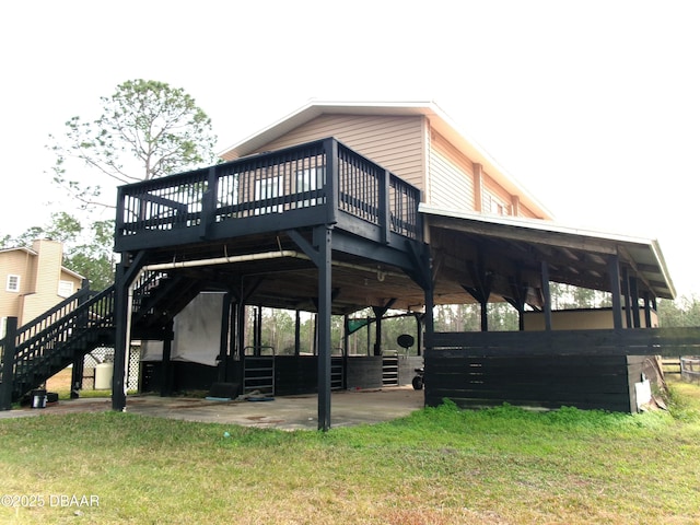 exterior space featuring a wooden deck, a yard, and a patio area