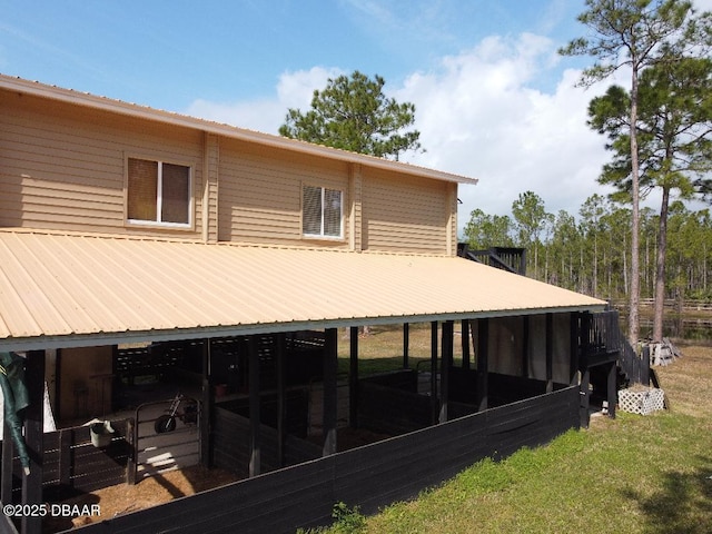 rear view of house featuring an outbuilding