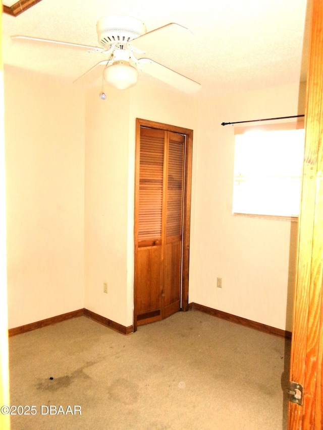 unfurnished bedroom featuring light carpet, a closet, and ceiling fan