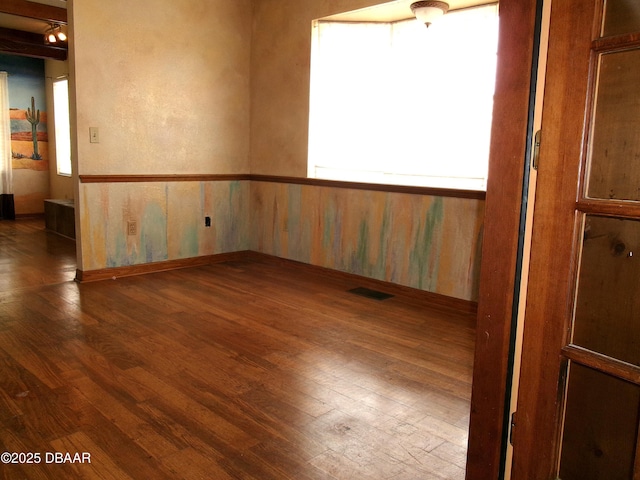 unfurnished room featuring dark hardwood / wood-style flooring