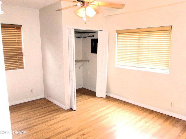 unfurnished bedroom featuring ceiling fan, light wood-type flooring, and a closet