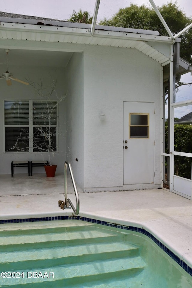 back of house with a patio, ceiling fan, and glass enclosure