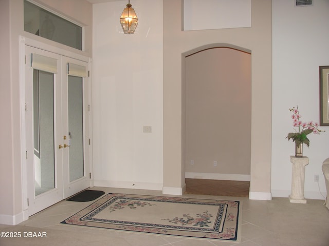 tiled entrance foyer featuring french doors