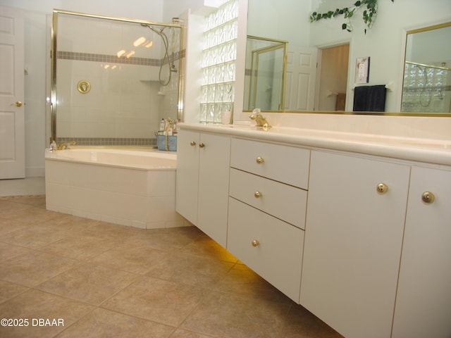 bathroom featuring plus walk in shower, tile patterned flooring, and vanity