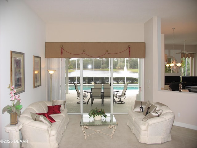 living room featuring carpet flooring and ceiling fan