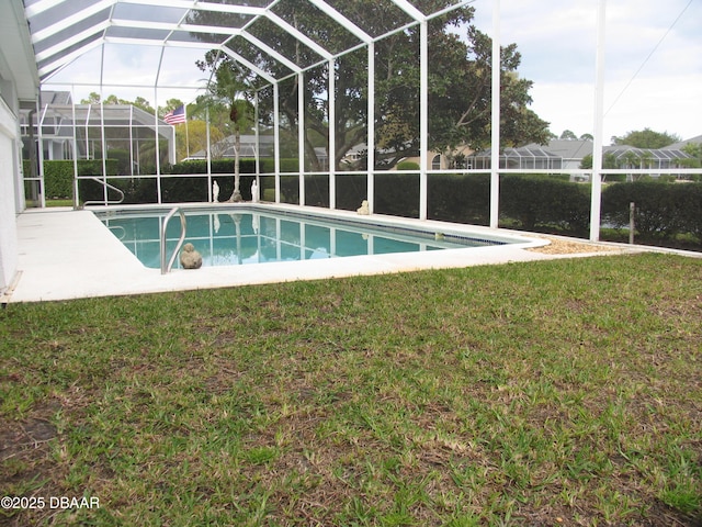 view of swimming pool featuring a yard and glass enclosure