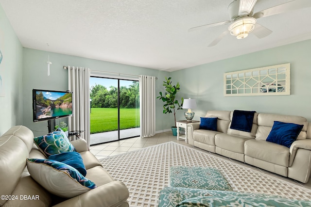 living room featuring ceiling fan, a textured ceiling, and light tile patterned floors