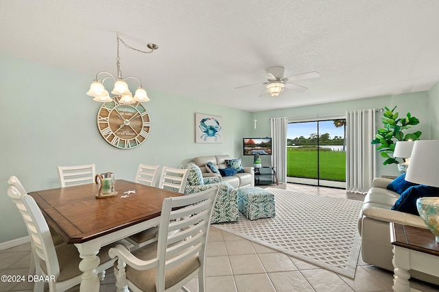 dining area featuring light tile patterned floors and ceiling fan with notable chandelier