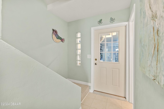 entryway with light tile patterned flooring