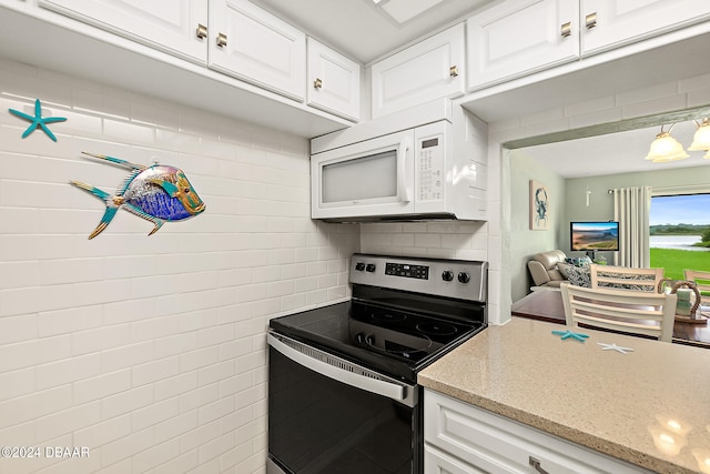 kitchen featuring white cabinetry, stainless steel range with electric cooktop, light stone counters, and tasteful backsplash