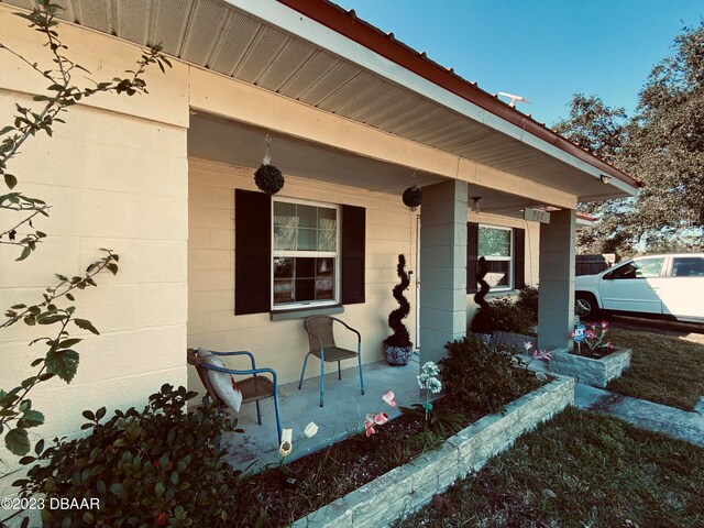 doorway to property featuring covered porch