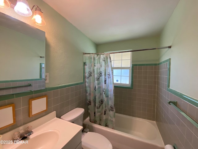 full bathroom with shower / tub combo with curtain, vanity, tile walls, and toilet