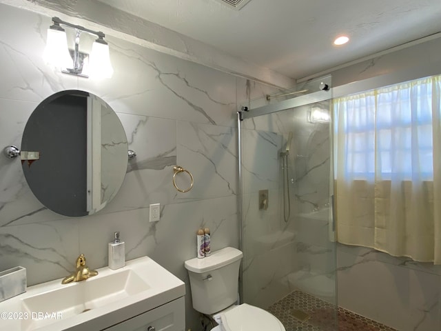 bathroom with an enclosed shower, vanity, tasteful backsplash, and toilet