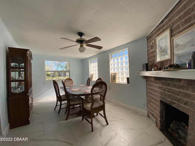 dining room with a fireplace and ceiling fan