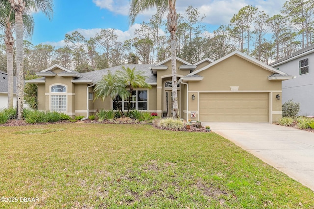 view of front of property with a garage and a front lawn