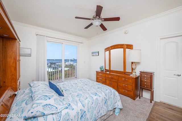 bedroom with access to outside, crown molding, a textured ceiling, light hardwood / wood-style floors, and ceiling fan