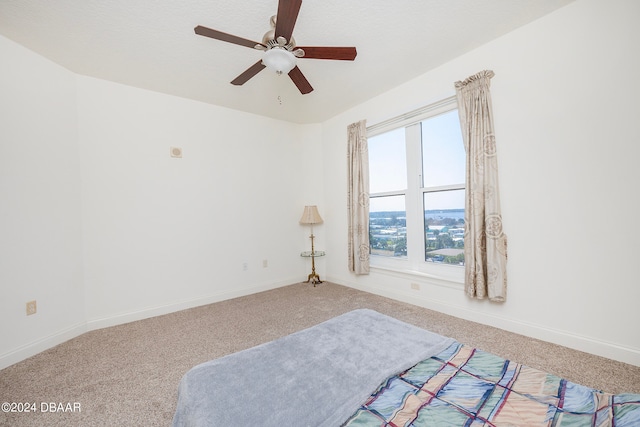 unfurnished bedroom featuring ceiling fan and carpet floors