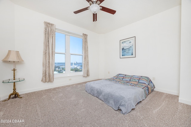 bedroom featuring ceiling fan and light carpet