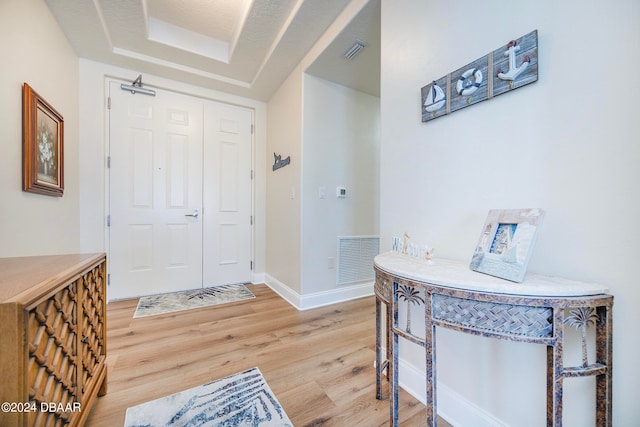 entryway with hardwood / wood-style floors and a textured ceiling