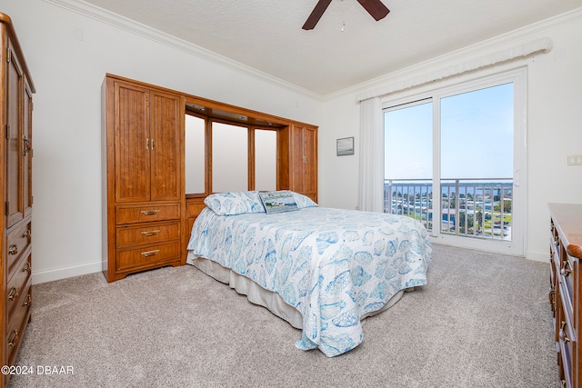 carpeted bedroom featuring ceiling fan, a textured ceiling, and ornamental molding