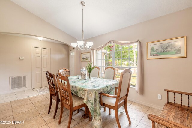1692 Old Tomoka Rd Unit W, Ormond Beach, FL 32174 - dining room featuring a chandelier, light tile patterned floors, vaulted ceiling, baseboards, and arched walkways