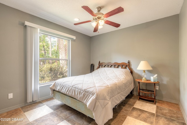 1692 Old Tomoka Rd Unit W, Ormond Beach, FL 32174 - bedroom with baseboards, ceiling fan, and a textured ceiling