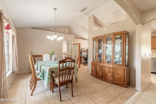 1692 Old Tomoka Rd Unit W, Ormond Beach, FL 32174 - dining area featuring vaulted ceiling, light tile patterned flooring, a chandelier, and arched walkways