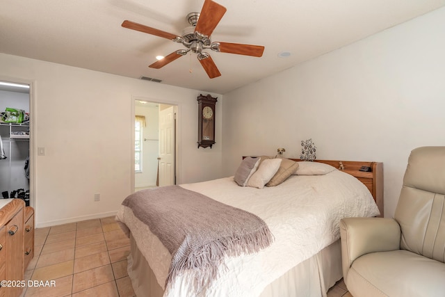 1692 Old Tomoka Rd Unit W, Ormond Beach, FL 32174 - bedroom with light tile patterned flooring, a walk in closet, ceiling fan, and baseboards